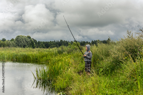 Teenboy fishing on the small river