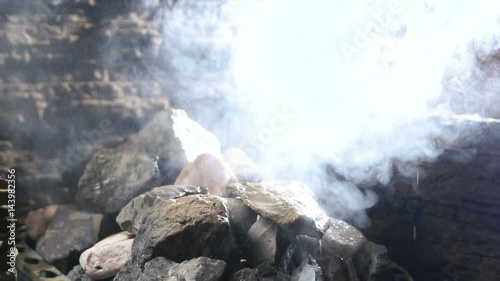Water flowing on the stone in sauna. Spa Still Life. wellness and spa concept, sauna interior. Slow motion