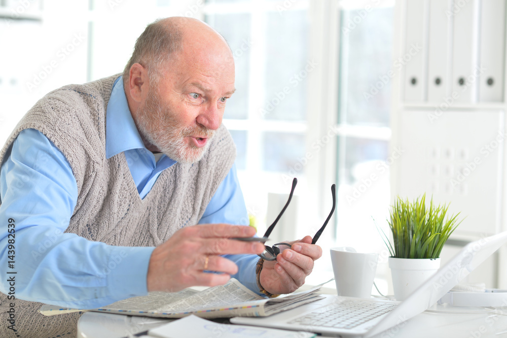 Elderly man with a laptop Elderly man with a laptop