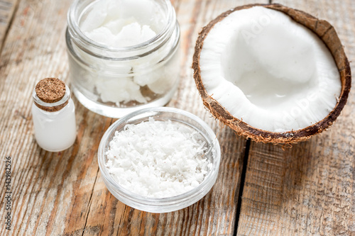 organic cosmetics with coconut on wooden background