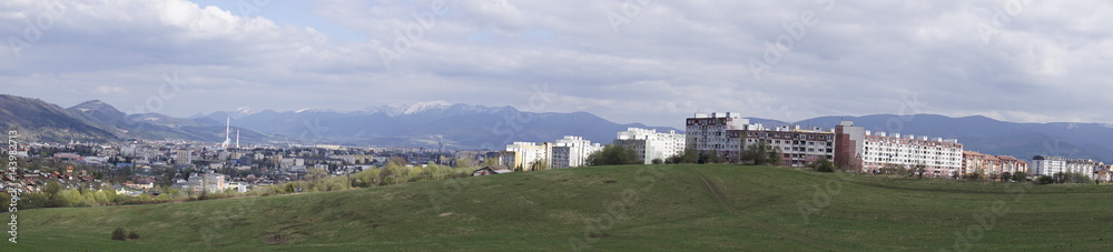 Panorama of mountain and city from meadow on a cloudy day. Slovakia