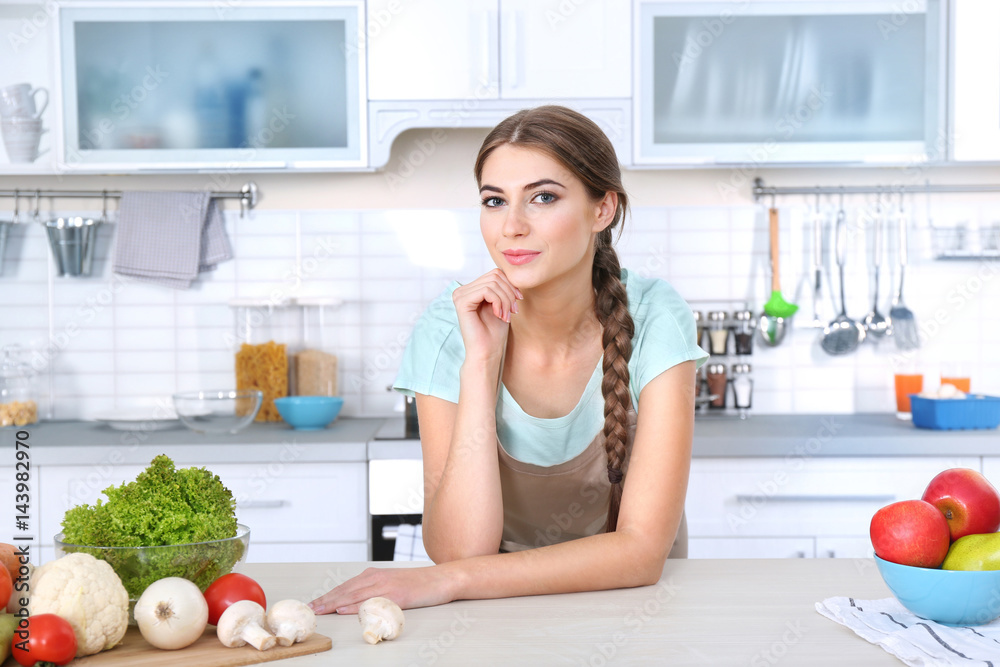 Portrait of young beautiful woman on kitchen Portrait of young beautiful woman on kitchen