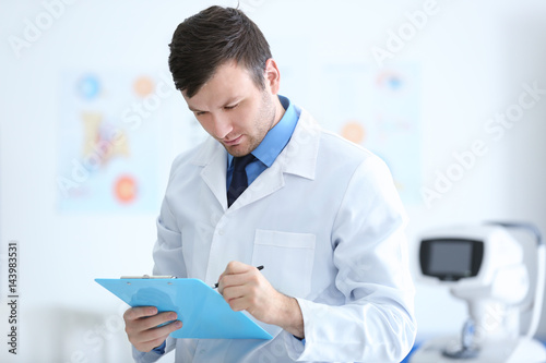 Young doctor with clipboard...