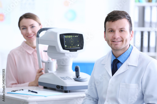 Male doctor examining adult...