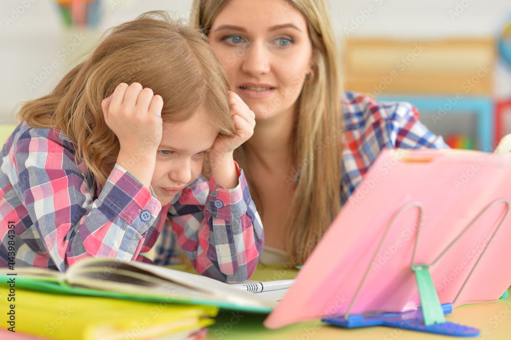 Mother and daughter doing their homework Mother and daughter doing their homework