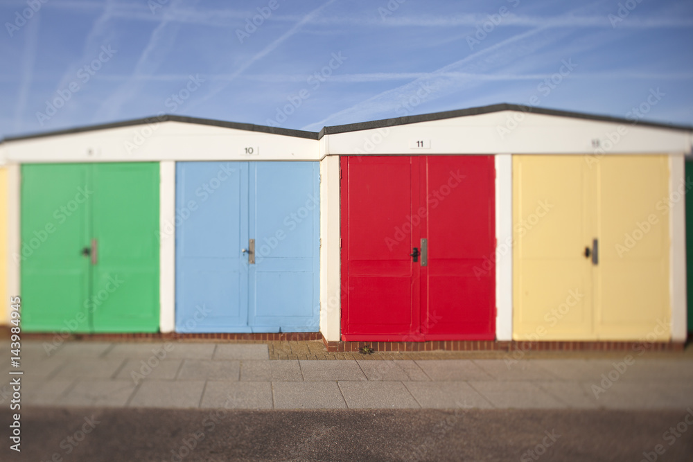 A row of colourful beach huts on the seafront at Exmouth, Devon, UK