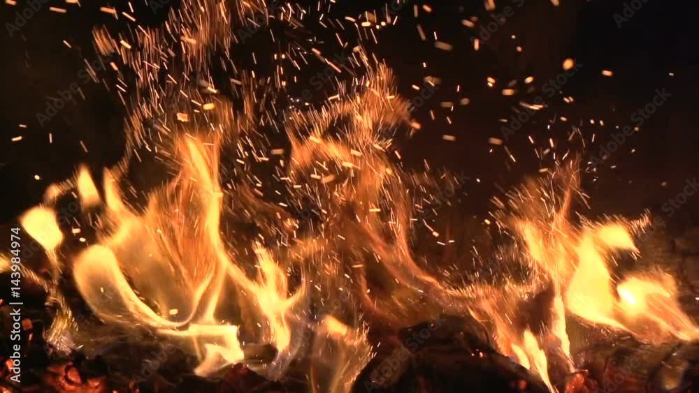 Warm cozy fire in a Home Fireplace. Real wood Burning in a Brick Fireplace Slow Panning shot. Home cosiness. Fireplace. Burning fire in a home fireplace, slow motion flames closeup. Slow motion