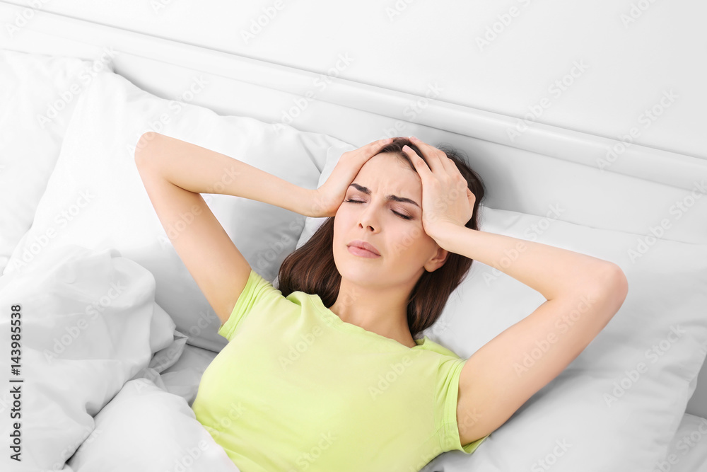Young sick woman lying in bed at home Young sick woman lying in bed at home