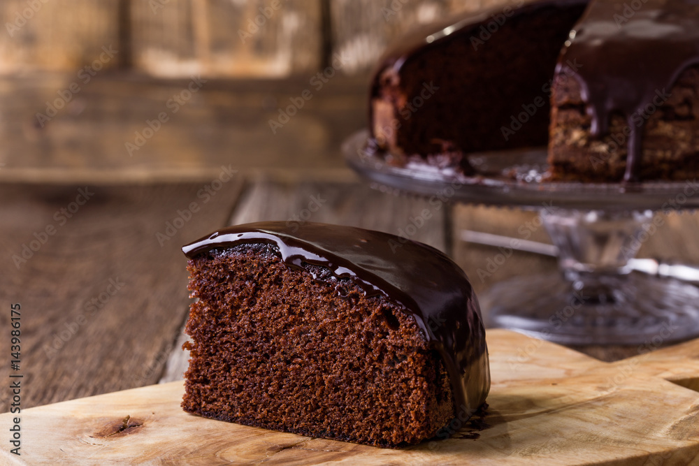 © istetiana - Slice of homemade chocolate cake on wooden table © istetiana - Slice of homemade chocolate cake on wooden table