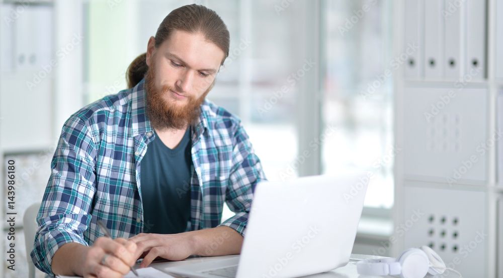Young business man with laptop working Young business man with laptop working