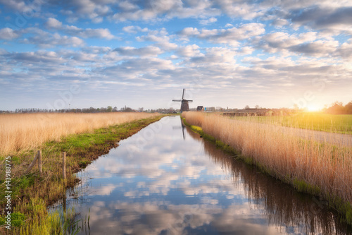 Windmills at sunrise. Rusti...