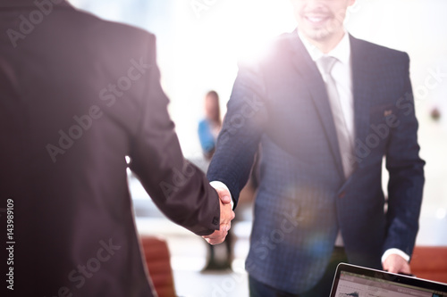 Close up view of business partnership handshake concept.Photo of two businessman handshaking process.Successful deal after great meeting.