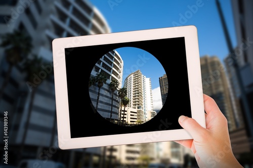 Composite image of masculine hand holding tablet photo