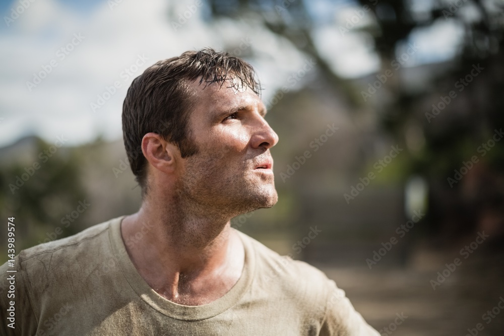 Military man standing during obstacle course Military man standing during obstacle course