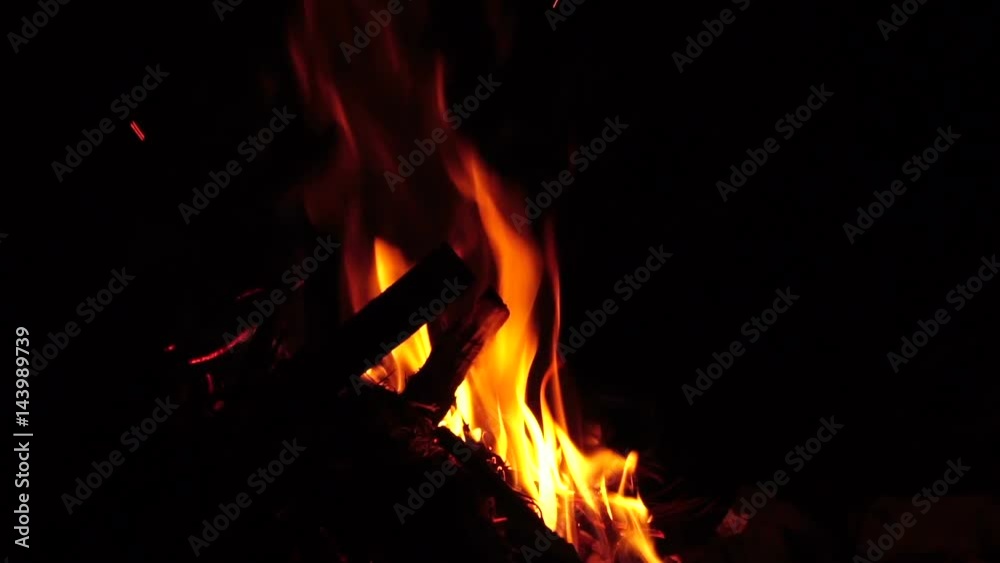 spurts of flame. Campfire in the night. Slow motion

