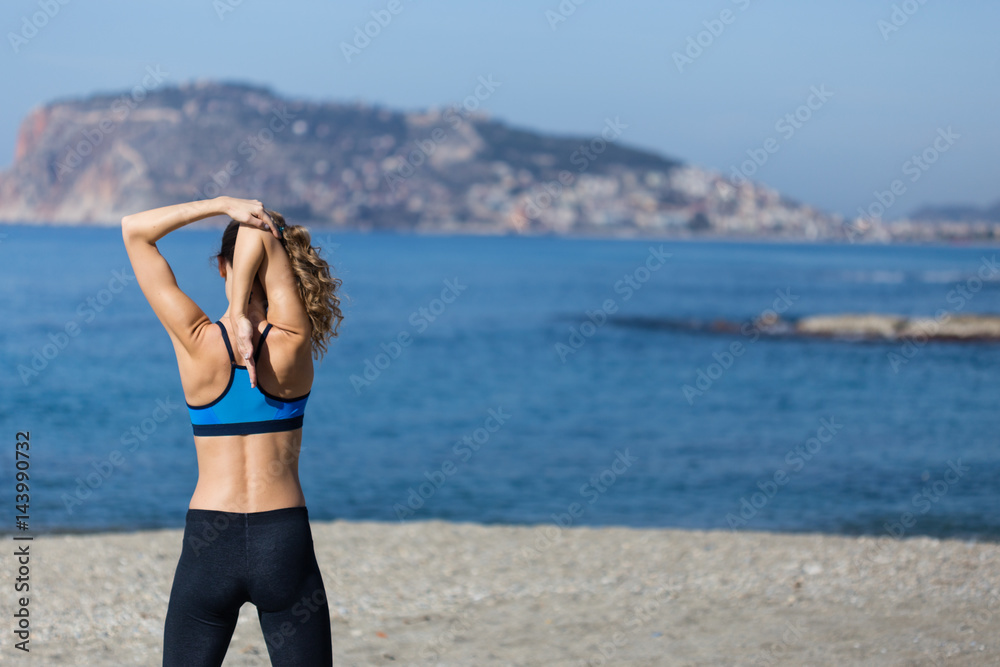 Healthy and fitness lifestyle Young woman stretching on beach in Healthy and fitness lifestyle Young woman stretching on beach in