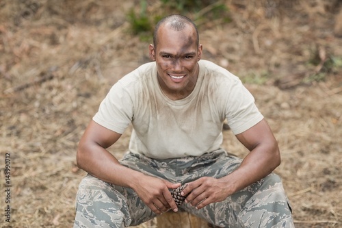 Military soldier relaxing during obstacle training