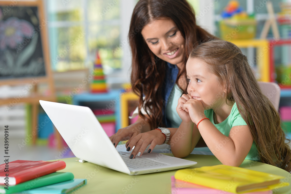 mother and daughter using laptop mother and daughter using laptop