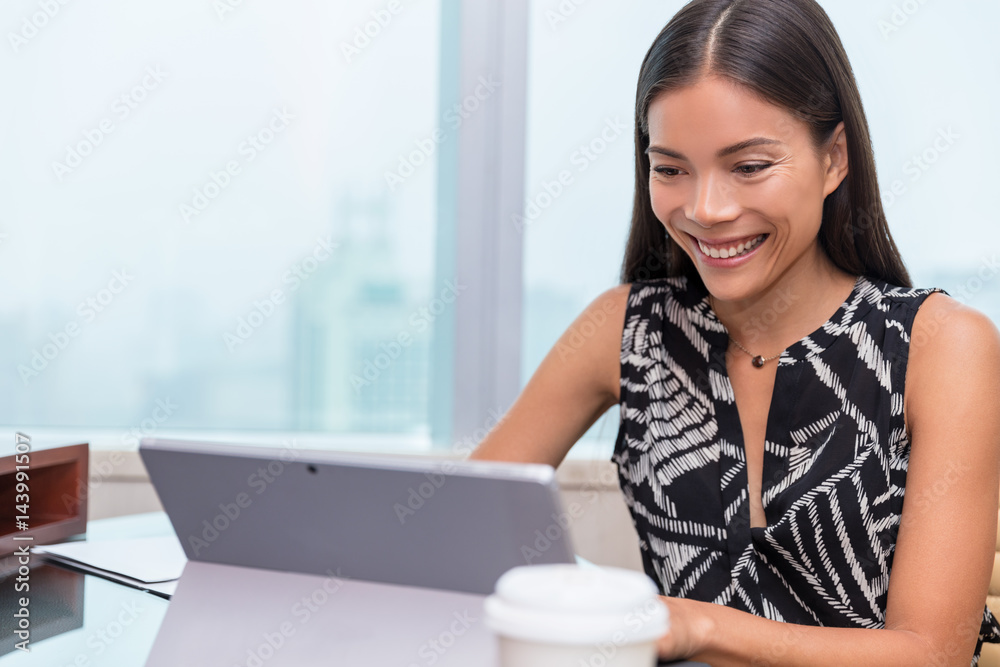 Asian woman smiling at laptop screen doing video chat conference online or working at office desk. Freelance work at home or customer service support. Asian woman smiling at laptop screen doing video chat conference online or working at office desk. Freelance work at home or customer service support.