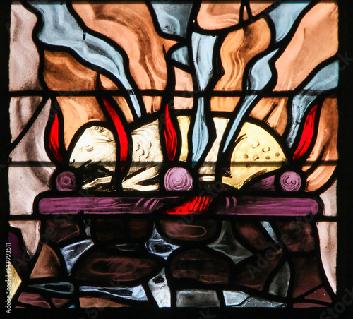 Foto Stained Glass of a burning lamb, symbolizing the Agnus Dei