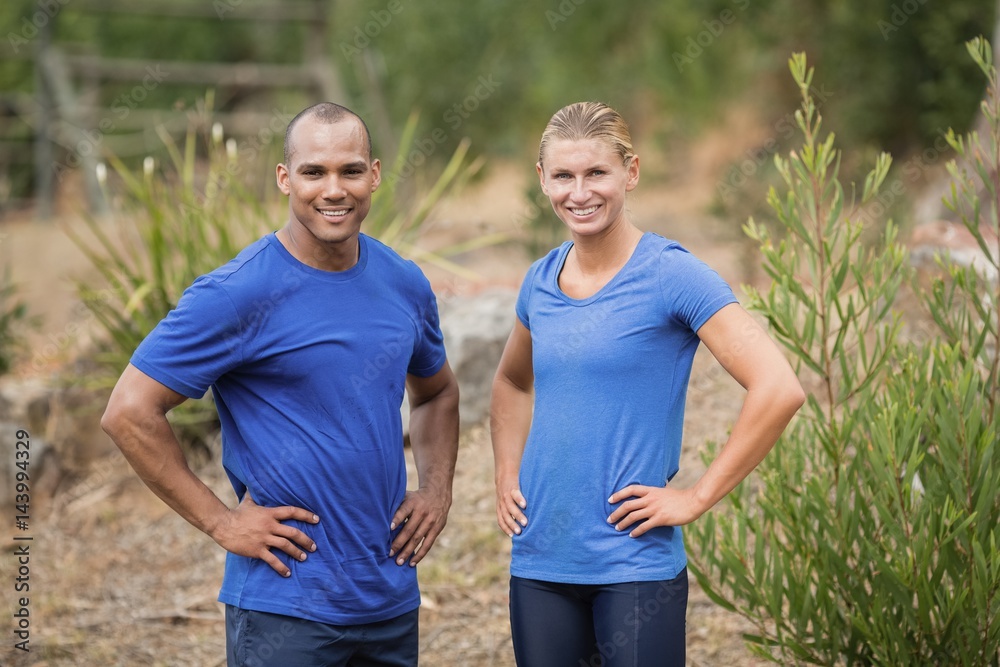 Fototapeta premium Fit man and woman standing with hands on hip 