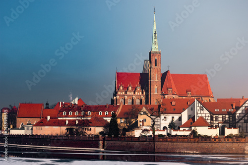 View on Church of the Holy Cross and St. Bartholomew, Odra river and Tumski Island, Wroclaw, Poland. Beautiful winter landscape.