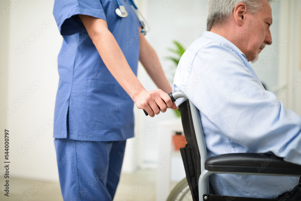 Nurse pushing a patients wheelchair Nurse pushing a patients wheelchair