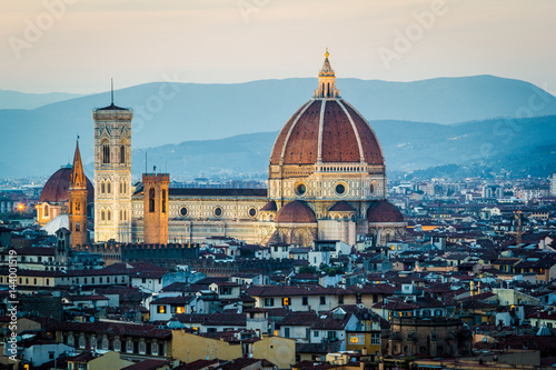 Florence, Tuscany, Italy. Cytiscape with the Cathedral and the Brunelleschi Dome, Giotto Tower at sunset, lights on. photo