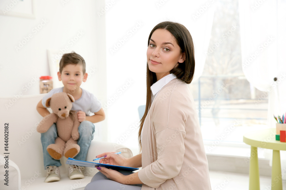 Young child psychologist working with little boy