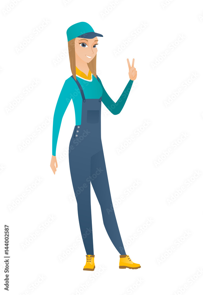 Caucasian mechanic showing the victory gesture. Caucasian mechanic showing the victory gesture.