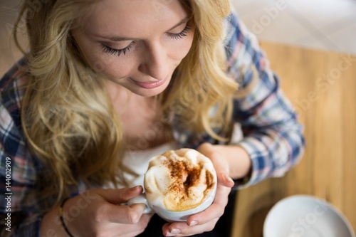 Young woman having coffee in cafe