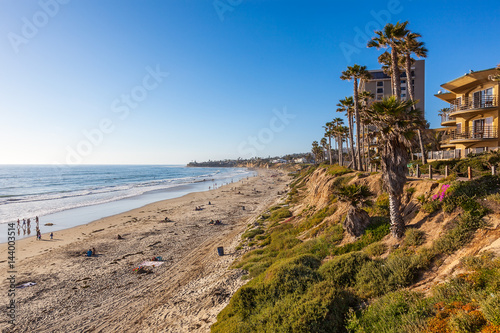 Late afternoon sun warms the bluffs in North Pacific Beach, California photo