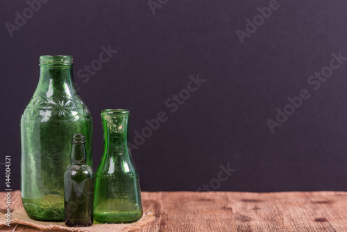 Green vintage bottles with black background