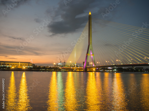 Rama VIII Bridge at night on the river in thailand