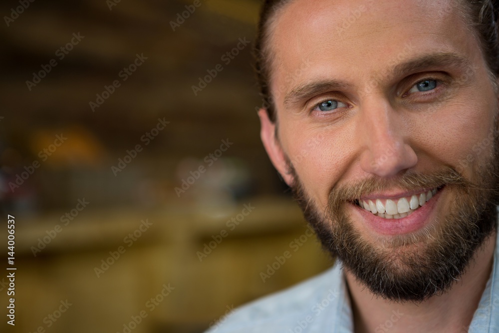 Close-up of young man smiling in cafeteria Close-up of young man smiling in cafeteria