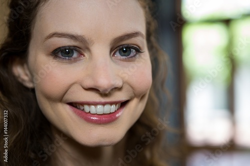 Portrait of beautiful woman smiling in coffee shop