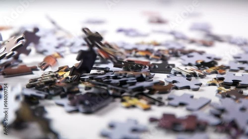 puzzle parts falling on white table