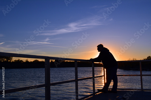 Fishing Sunset/Man standing on a dock at sunset fishing