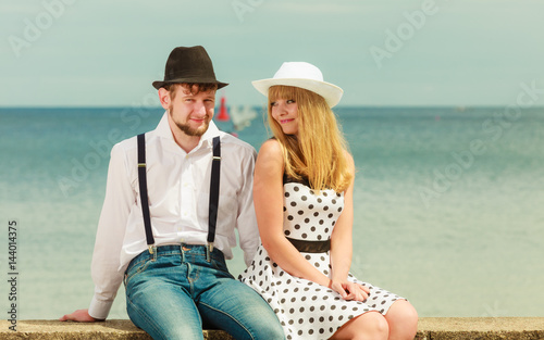 Loving couple retro style dating on sea coast