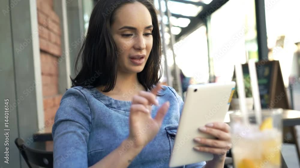 Young woman using tablet sitting in cafe in city
Young woman using tablet sitting in cafe in city