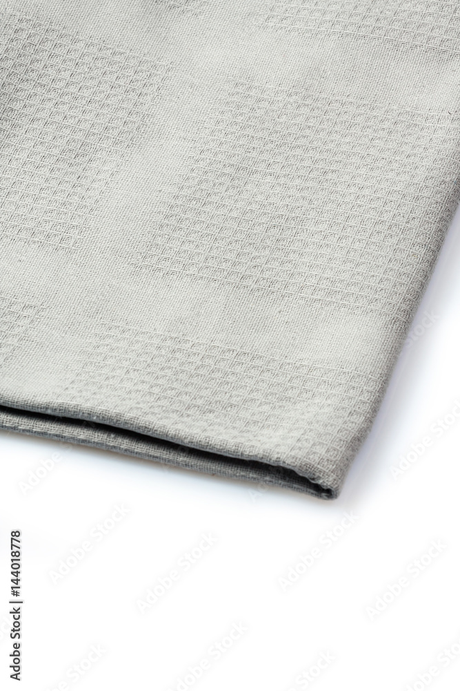 Folded grey napkin on white background, close up Folded grey napkin on white background, close up