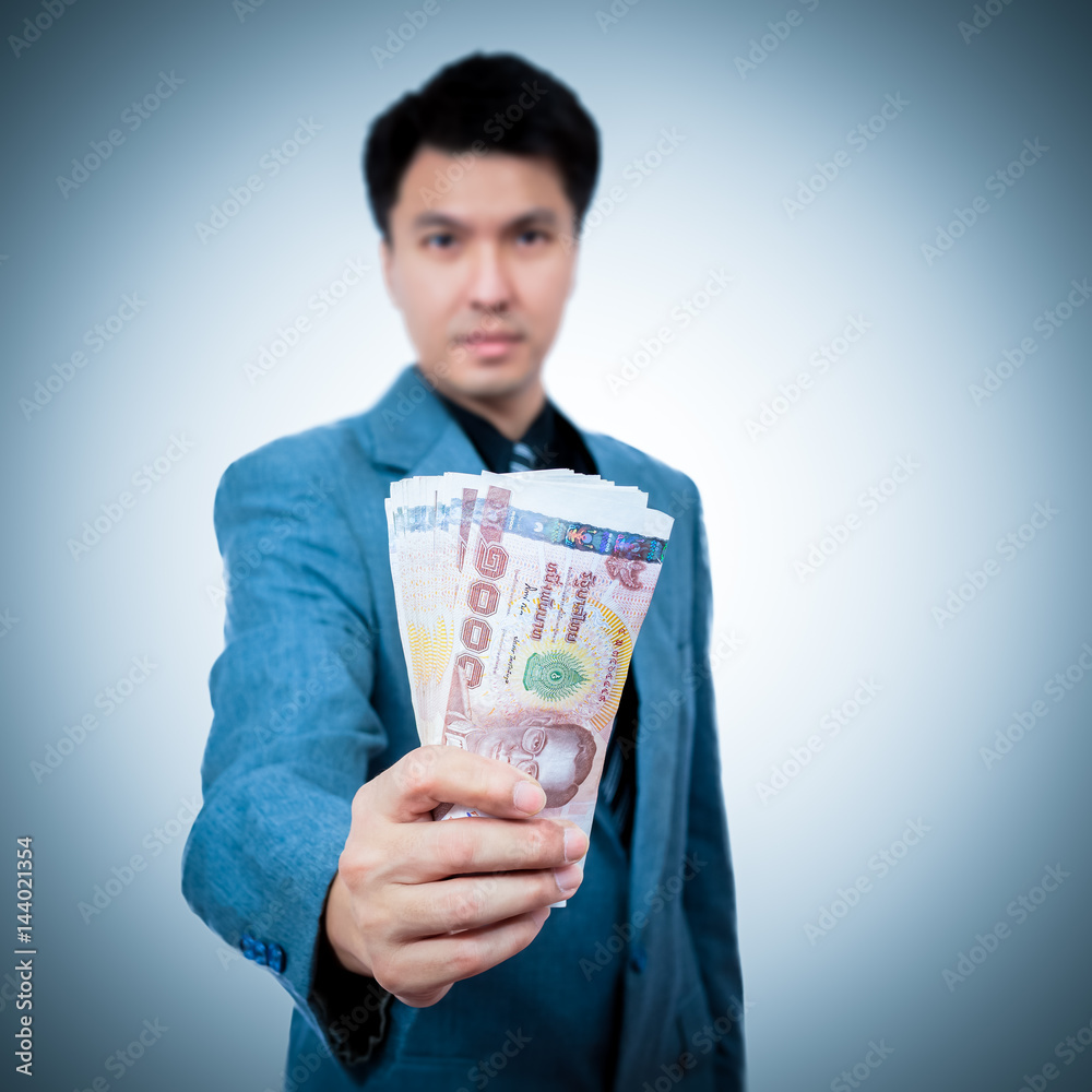 asian handsome businessman in suit showing banknotes