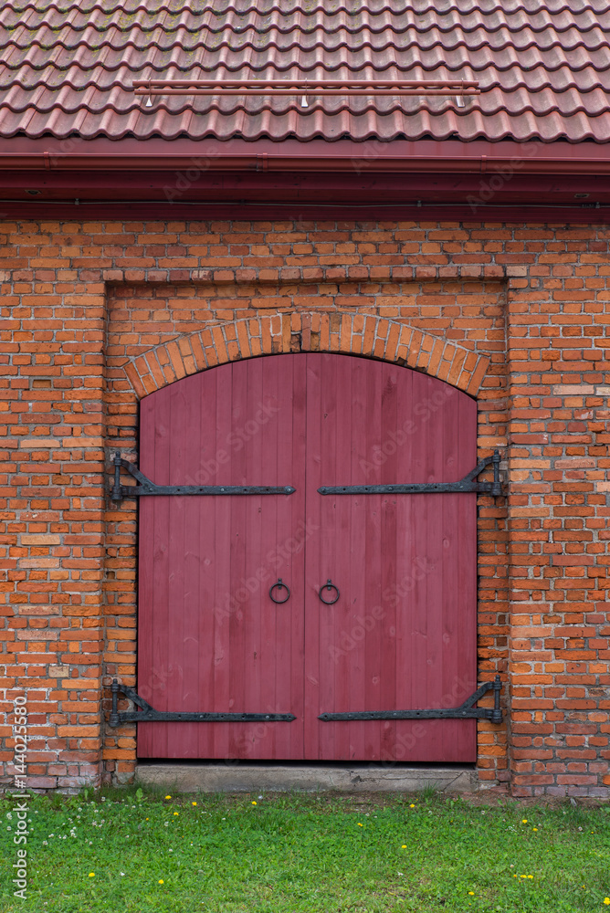 the Red brick wall and the wooden closed door