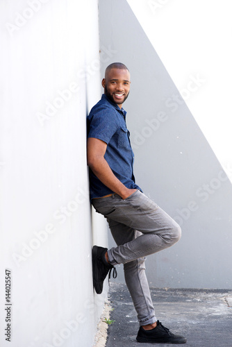 Full length stylish young black standing by wall © mimagephotos