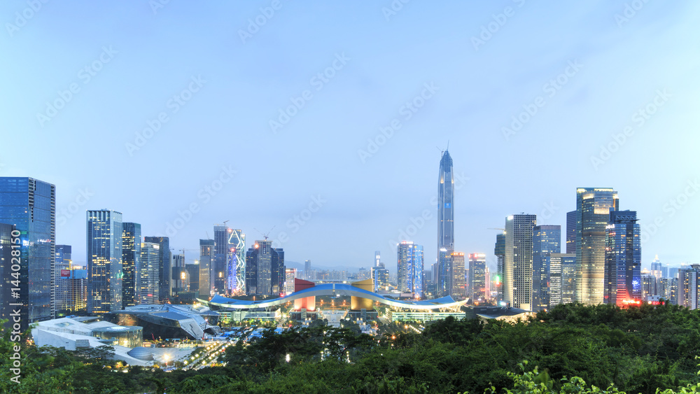Shenzhen cityscape at dusk with the Civic Center and the Ping An IFC on foreground, China Shenzhen cityscape at dusk with the Civic Center and the Ping An IFC on foreground, China