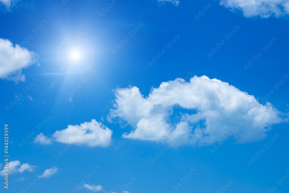 Blue sky with white cloud and sunlight.
