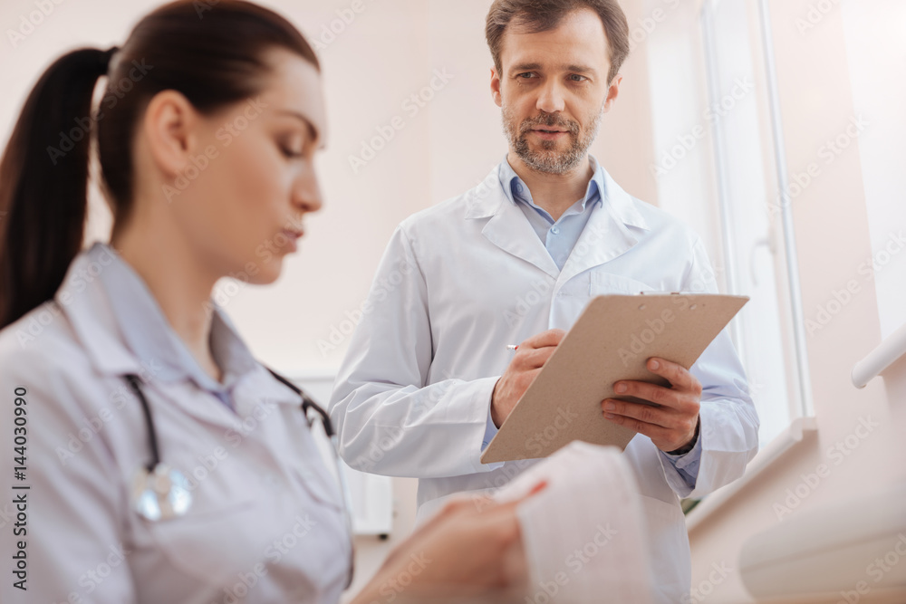 Skillful precise doctor seeking colleagues consultation Skillful precise doctor seeking colleagues consultation