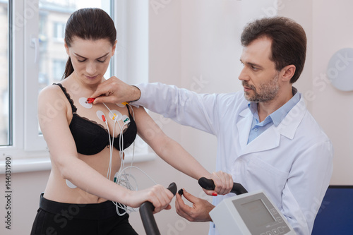 Excellent scrupulous doctor making sure the equipment working right