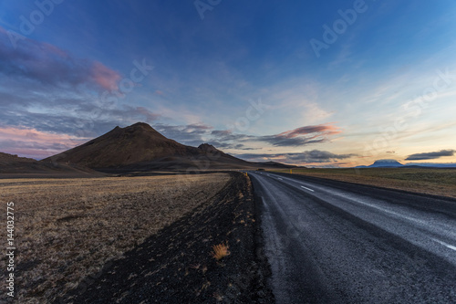 Wild nature landscape at sunset. Dark road i Iceland