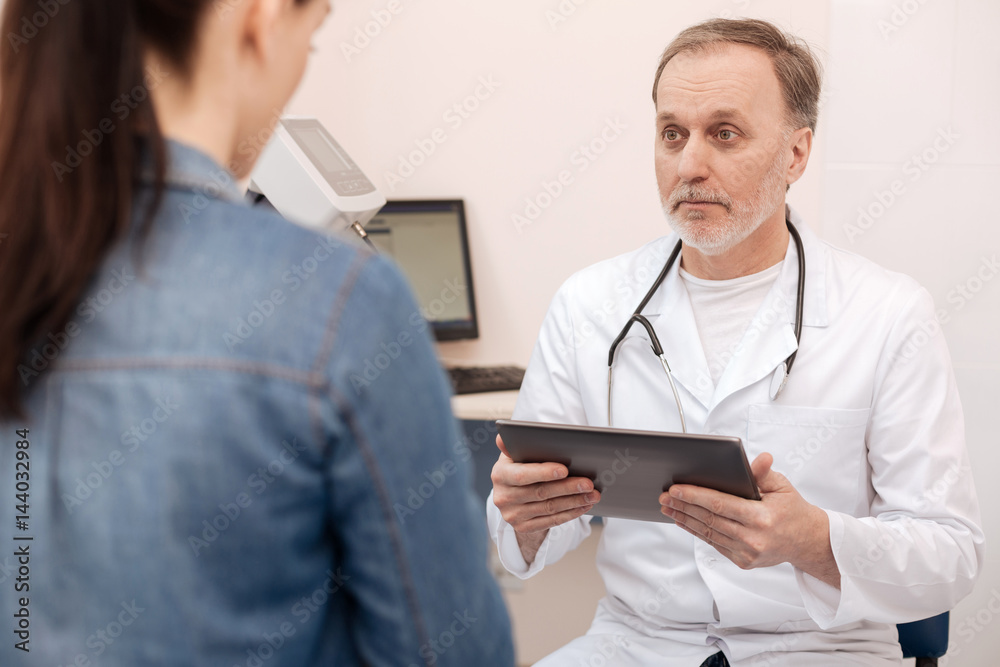 Qualified mature specialist consulting a young woman